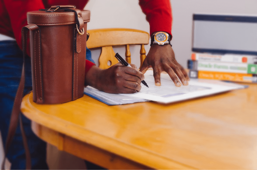 A photo of a man signing a document